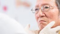 Doctor checking throat for an elder patient